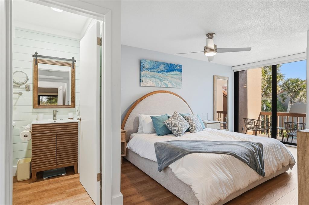 208 Pass Key Road, Unit 208 Sarasota, FL 34242 - Photo 12 of 29 a bedroom with a bed and wooden floor