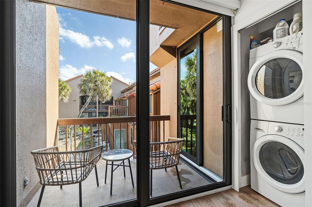 208 Pass Key Road, Unit 208 Sarasota, FL 34242 - Photo 14 of 29 a view of a balcony with furniture and a fireplace