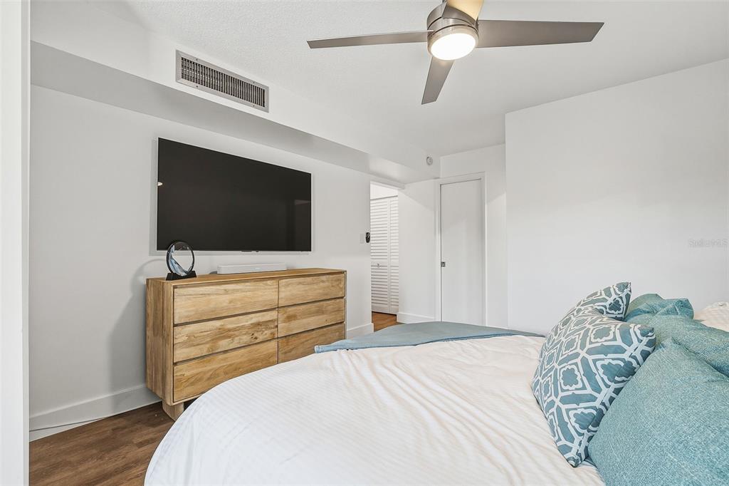 208 Pass Key Road, Unit 208 Sarasota, FL 34242 - Photo 15 of 29 a bedroom with a bed and a flat screen tv