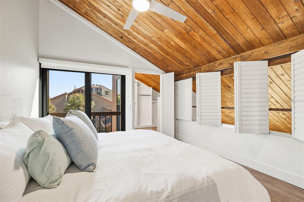 208 Pass Key Road, Unit 208 Sarasota, FL 34242 - Photo 18 of 29 a bedroom with a large bed and a large window