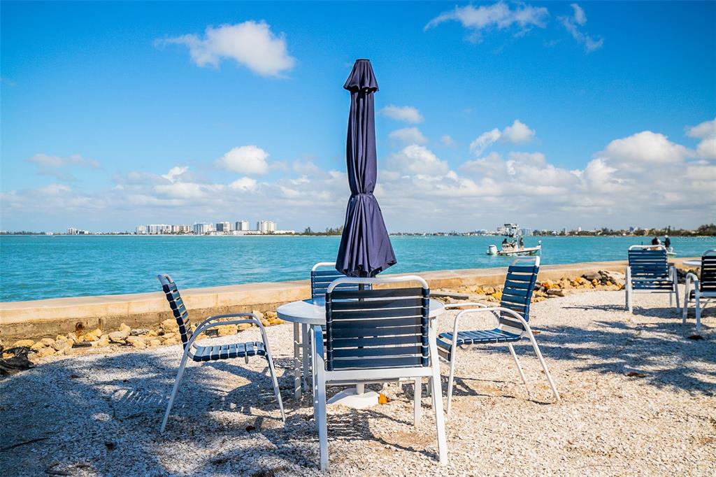 208 Pass Key Road, Unit 208 Sarasota, FL 34242 - Photo 25 of 29 a view of a patio with a table and chairs