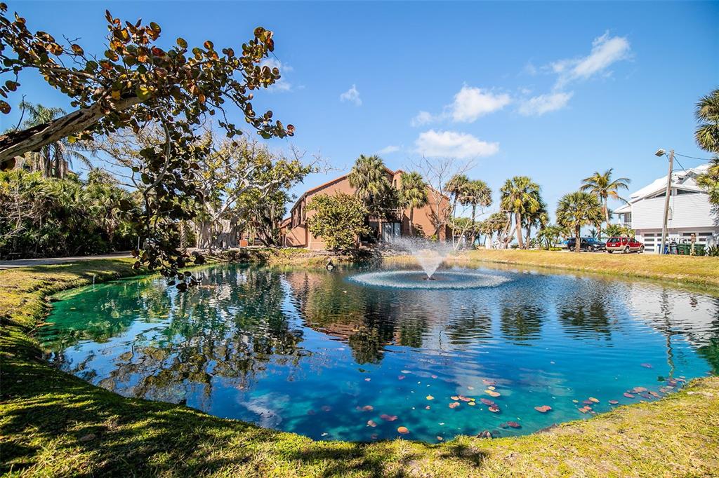 208 Pass Key Road, Unit 208 Sarasota, FL 34242 - Photo 29 of 29 a view of a house with a yard and sitting area