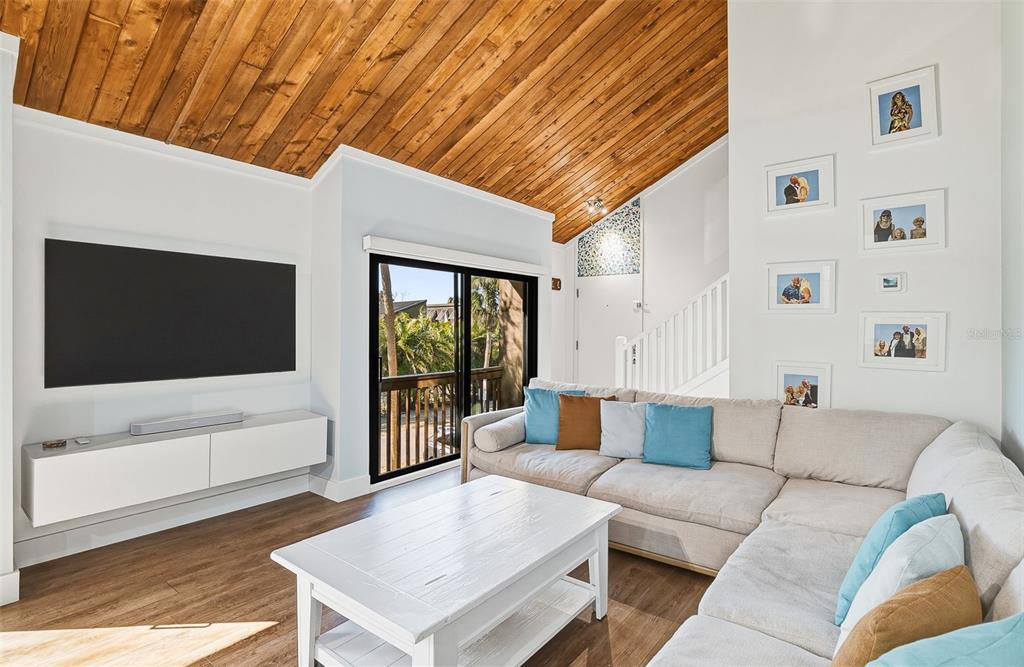 208 Pass Key Road, Unit 208 Sarasota, FL 34242 - Photo 6 of 29 a living room with furniture and a flat screen tv