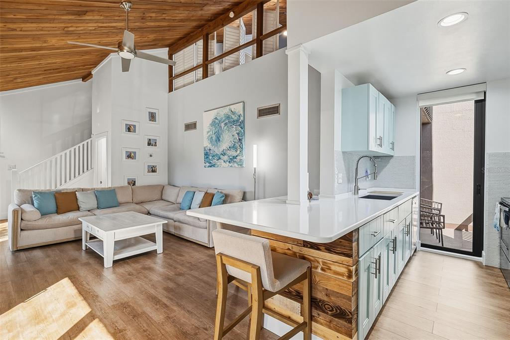 208 Pass Key Road, Unit 208 Sarasota, FL 34242 - Photo 7 of 29 a living room with furniture and a kitchen