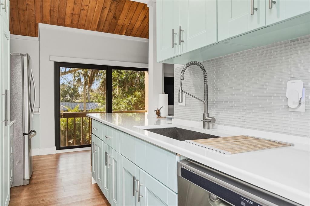 208 Pass Key Road, Unit 208 Sarasota, FL 34242 - Photo 10 of 29 a kitchen with a sink stove and cabinets