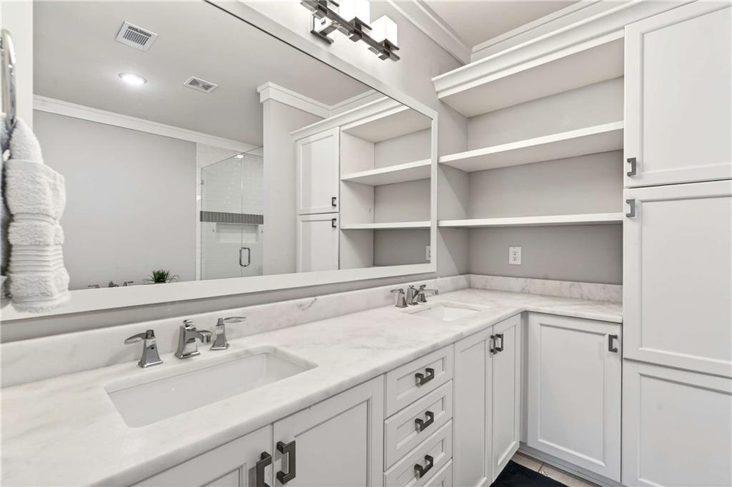 2974 Hermance Drive Northeast Atlanta, GA 30319 - Photo 18 of 38 a bathroom with a sink double vanity and a mirror