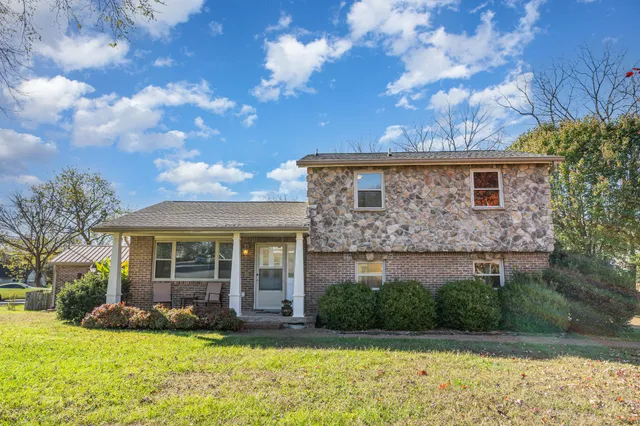 a view of house with a yard