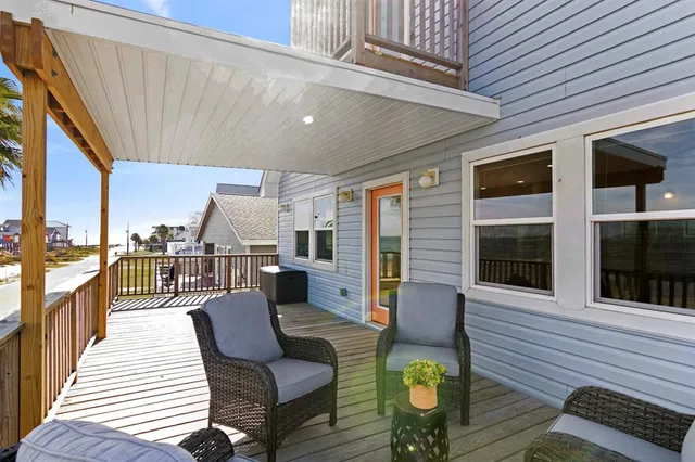 a balcony view with couple of chairs and wooden floor