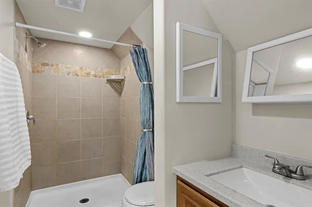 a bathroom with a sink toilet and shower