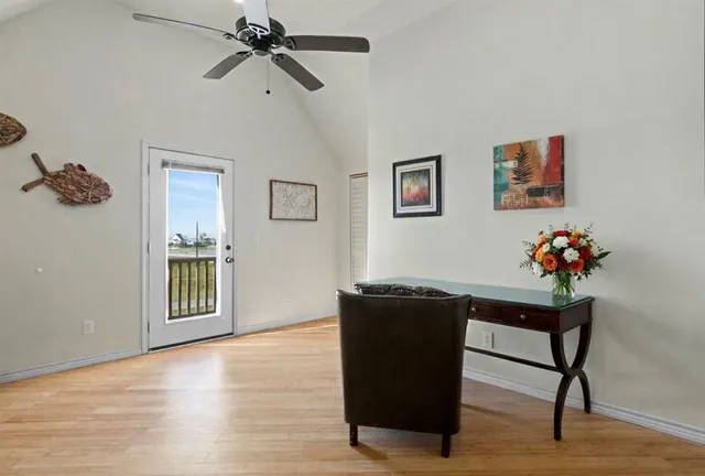 a view of a workspace with furniture and wooden floor