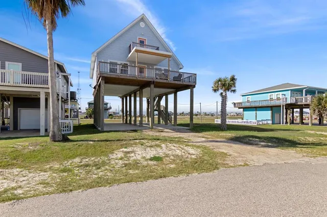 a view of a house with a yard and balcony