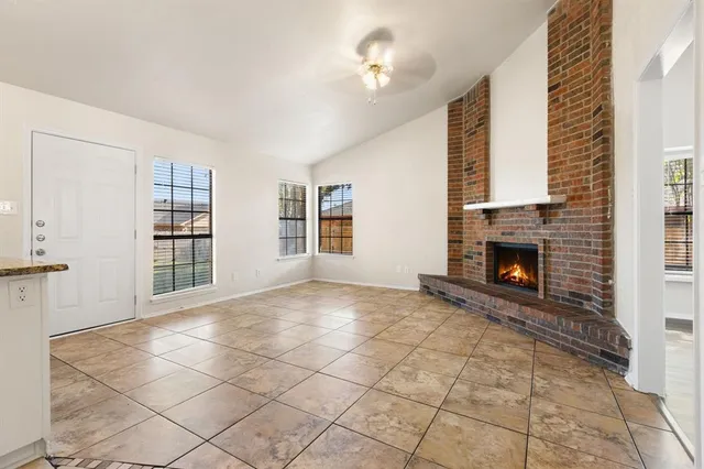 a view of a livingroom with a fireplace and window