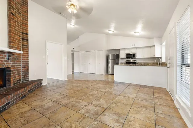 a view of a kitchen with microwave and cabinets