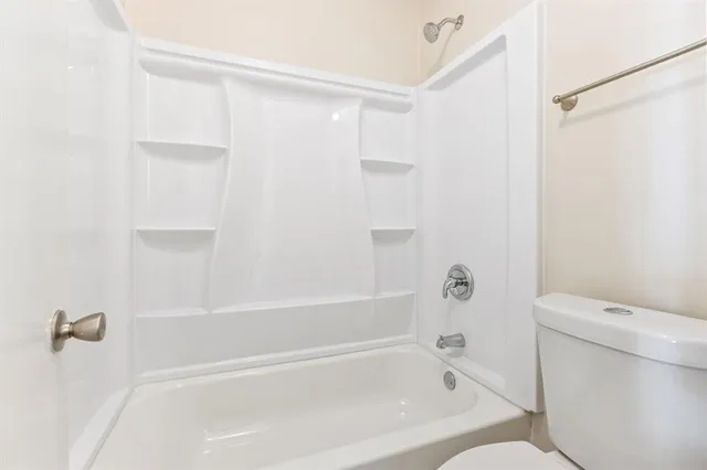 a bathroom with a bathtub and a toilet