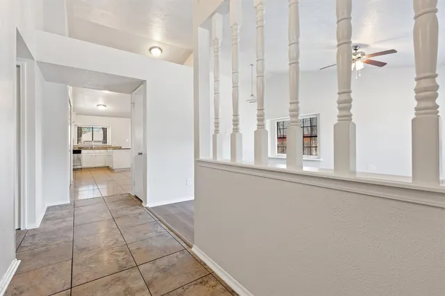 a view of a hallway with a cabinet and a living room