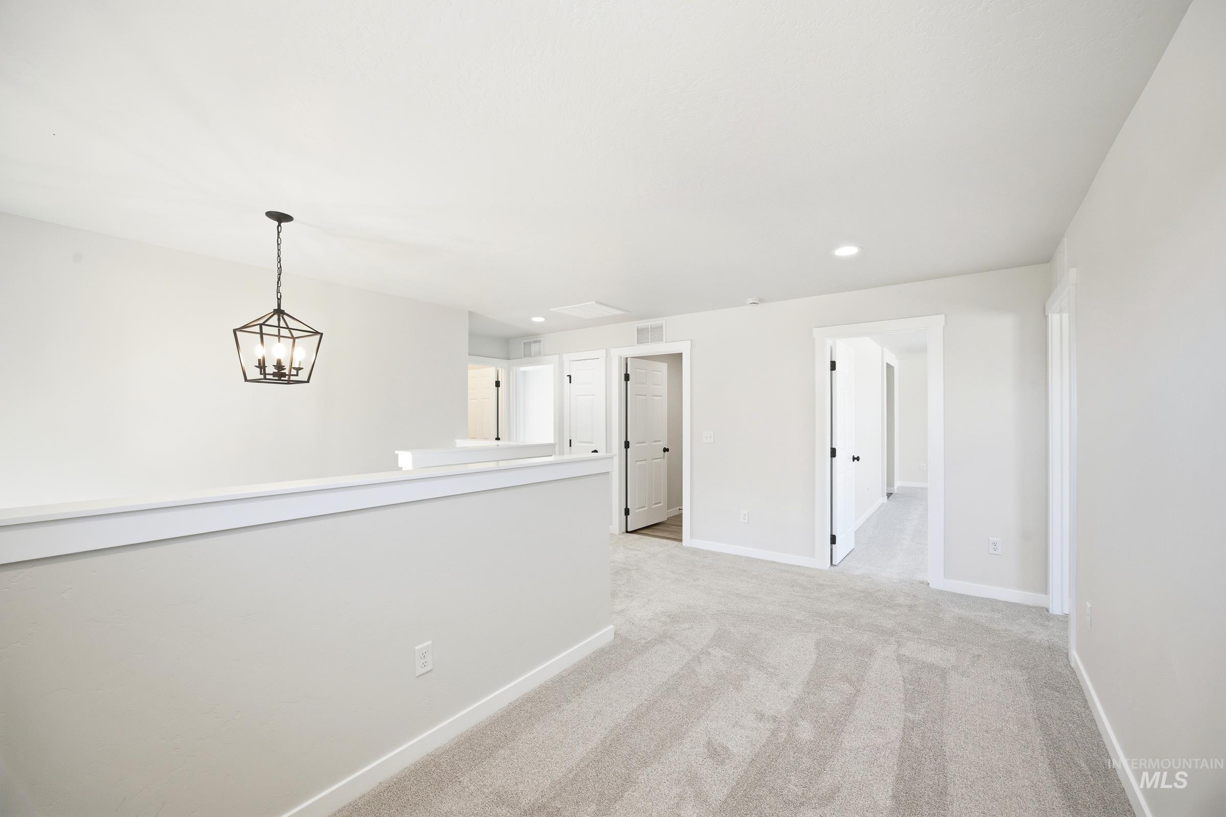 12841 Decatur Street Nampa, ID 83651 - Photo 22 of 30 Open loft space featuring light neutral wall tones and coordinating carpet