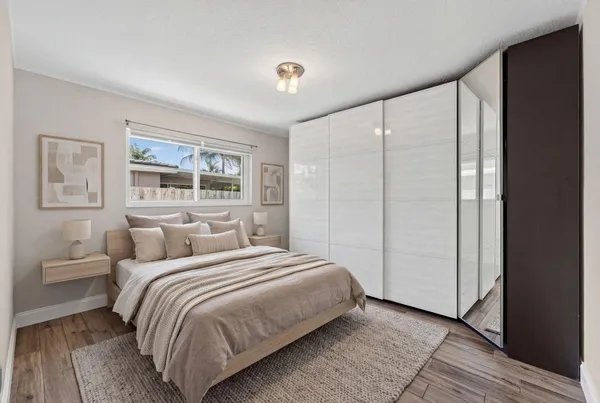 a bedroom with a large bed and a window