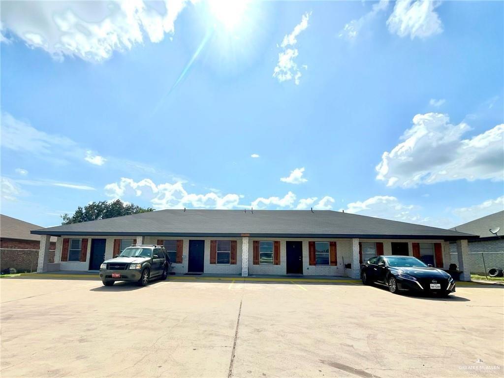 a view of a house with a yard covered in snow