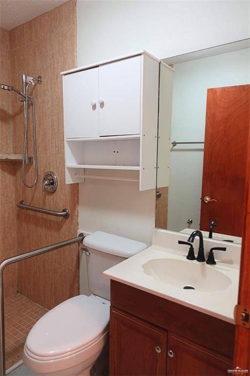 3401 North Inspiration Road, Unit 1 Mission, TX 78573 - Photo 6 of 9 a bathroom with a sink a toilet and shower