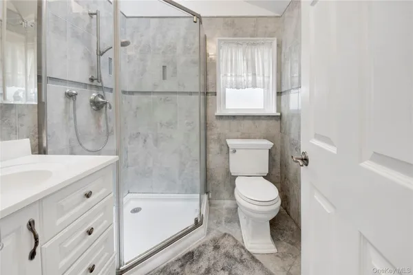 a bathroom with a granite countertop toilet a sink and bathtub