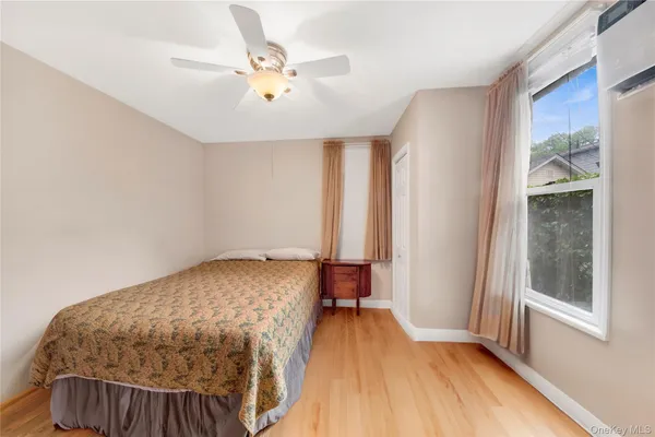 a bedroom with a bed and a window