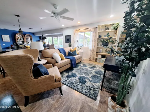 a living room with furniture and a potted plant