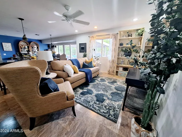 a living room with furniture and a potted plant