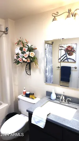 a bathroom with a tub a sink and a shower curtain