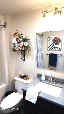 a bathroom with a tub a sink and a shower curtain