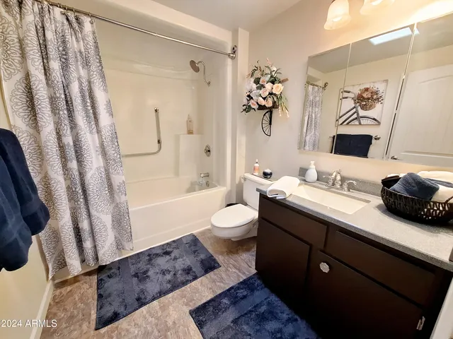 a bathroom with a sink mirror and toilet
