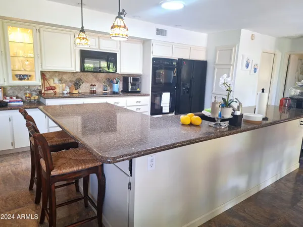 a spacious bathroom with a double vanity sink toilet mirror and shower