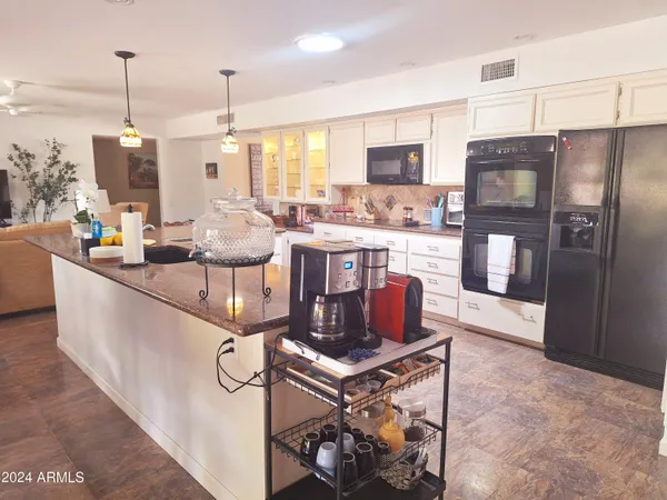 a kitchen with a table chairs and refrigerator
