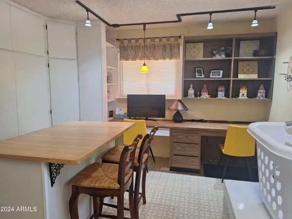 a view of a room that has a table and chairs