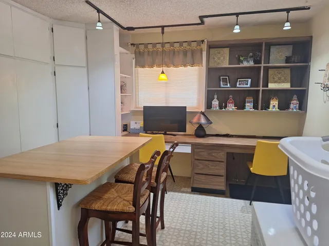 a view of a room that has a table and chairs