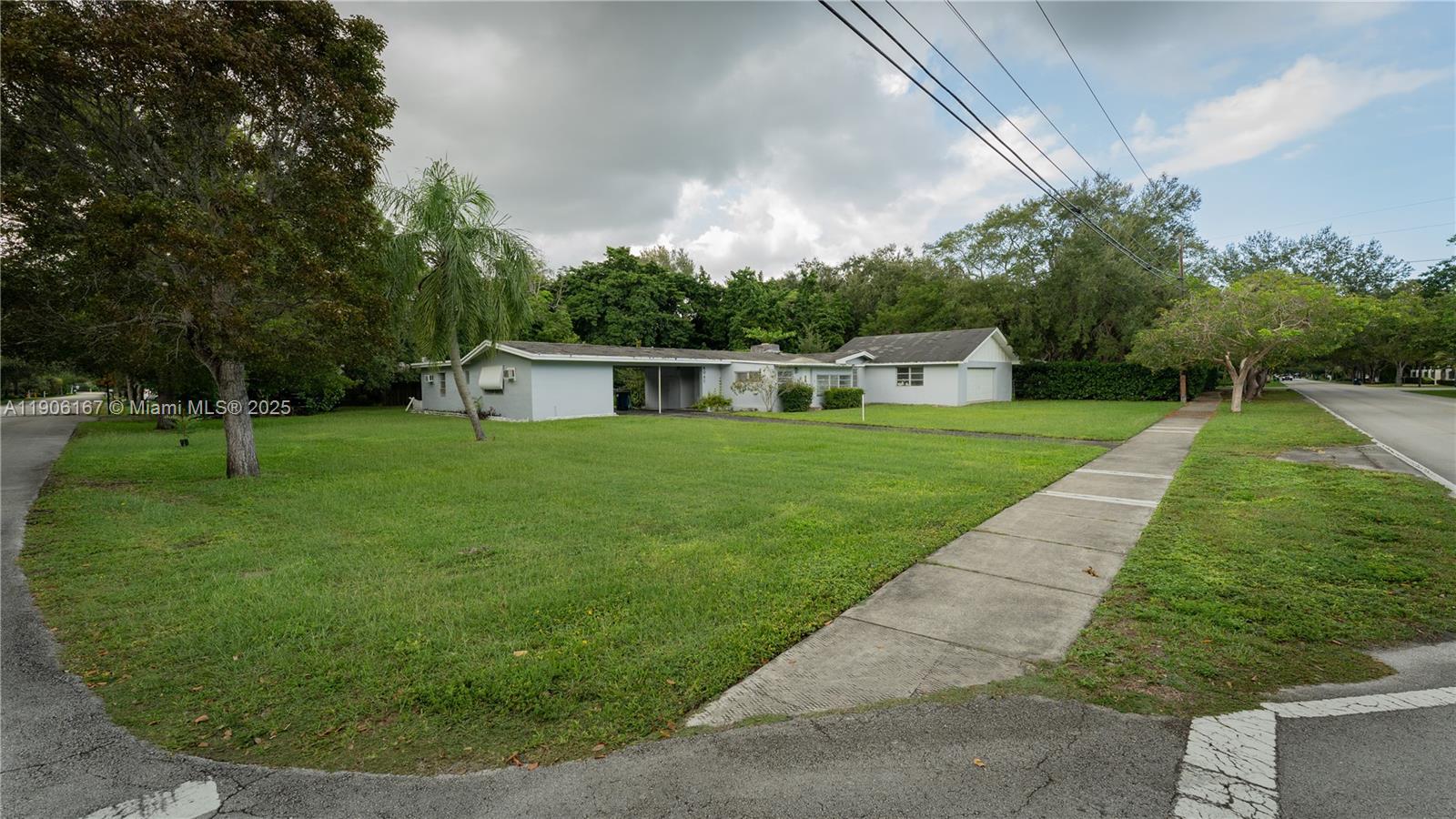 8045 Southwest 128th Street Pinecrest, FL 33156 - Photo 2 of 7 a view of a backyard with green space