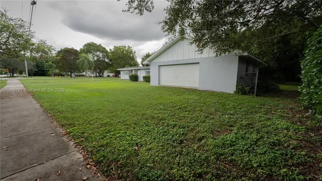 a view of a backyard with large trees