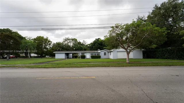 a front view of house with yard and green space