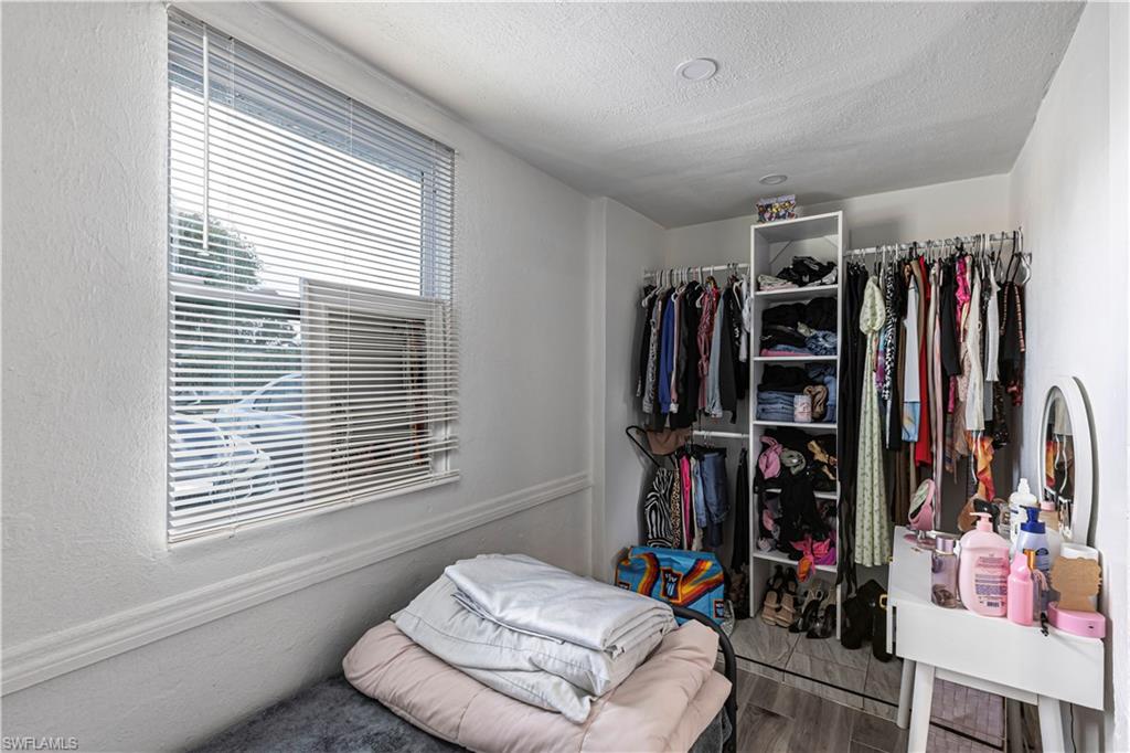 3132 Francis Avenue Naples, FL 34112 - Photo 11 of 23 a view of walk in closet with clothes and shoes