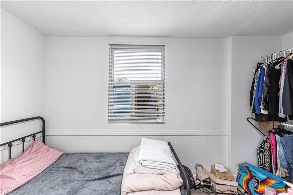 3132 Francis Avenue Naples, FL 34112 - Photo 12 of 23 a view of a bedroom with baby crib and a window