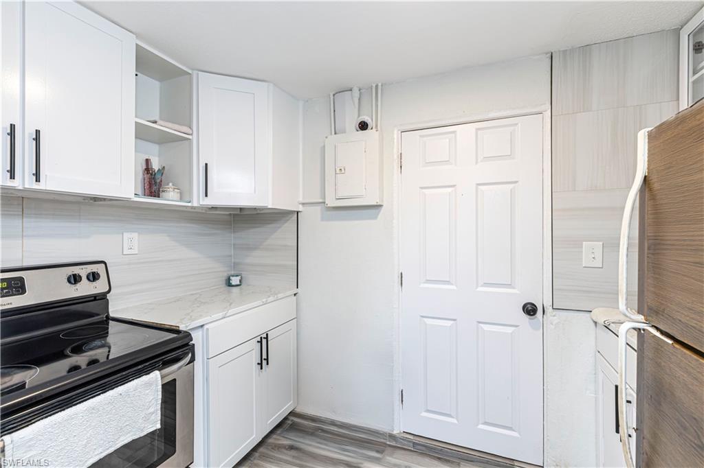 3132 Francis Avenue Naples, FL 34112 - Photo 13 of 23 a kitchen with white cabinets and white appliances