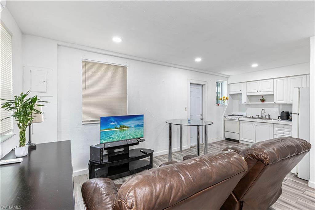 3132 Francis Avenue Naples, FL 34112 - Photo 14 of 23 a living room with furniture and a flat screen tv