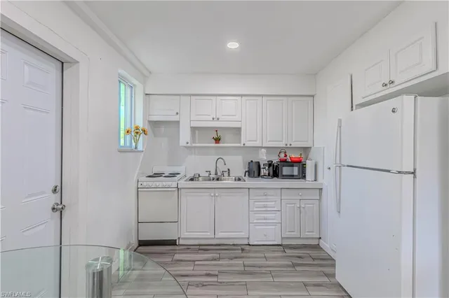 a kitchen with stainless steel appliances a refrigerator sink and cabinets