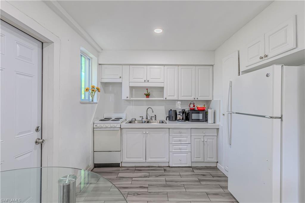 3132 Francis Avenue Naples, FL 34112 - Photo 16 of 23 a kitchen with stainless steel appliances a refrigerator sink and cabinets