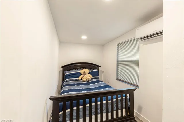 a bedroom with a bed and a window