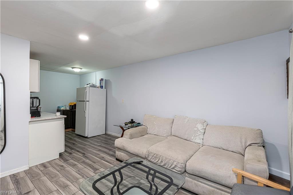 3132 Francis Avenue Naples, FL 34112 - Photo 2 of 23 a living room with furniture a refrigerator and a couch