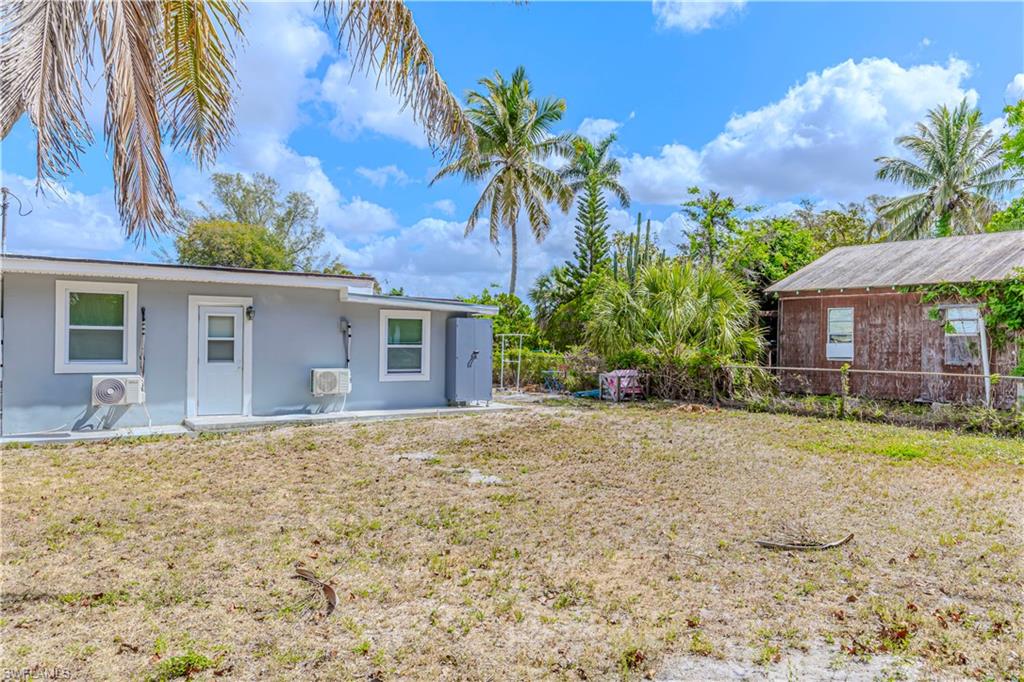 3132 Francis Avenue Naples, FL 34112 - Photo 22 of 23 a front view of a house with a garden and yard