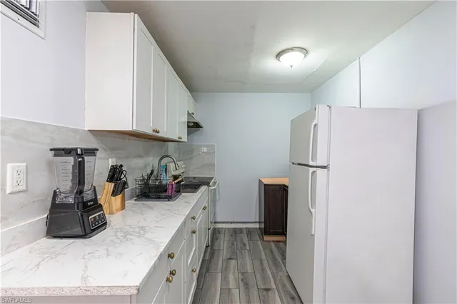 a kitchen with a refrigerator and a stove