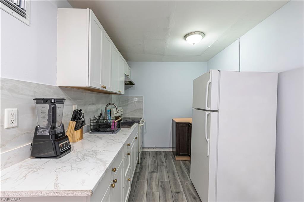 3132 Francis Avenue Naples, FL 34112 - Photo 5 of 23 a kitchen with a refrigerator and a stove