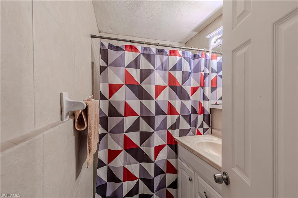 3132 Francis Avenue Naples, FL 34112 - Photo 7 of 23 a bathroom with a sink and a mirror