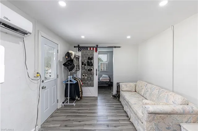 a living room with furniture and a ceiling fan